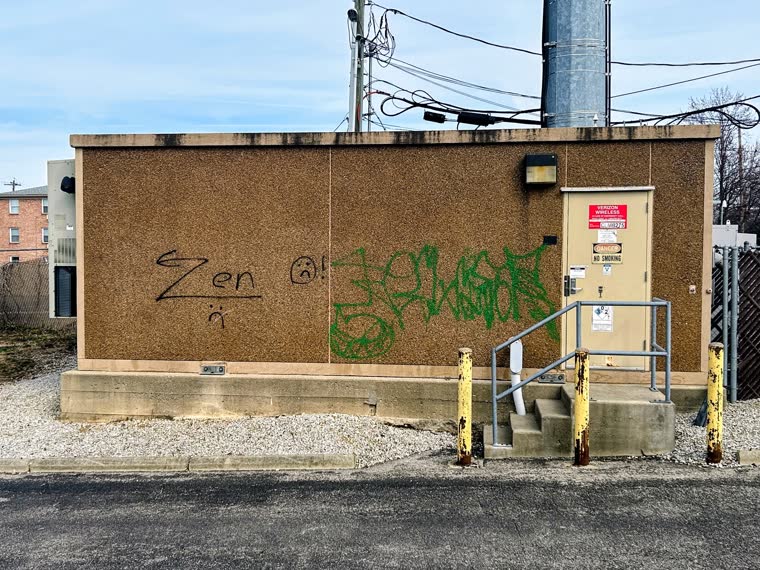 Graffiti removal preparation by Rubber City Power Wash